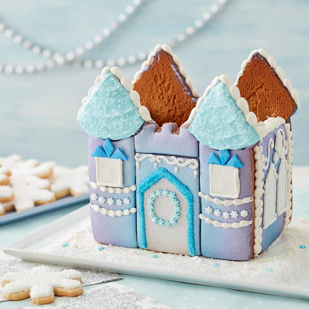winter-gingerbread-castle Winter princess castle with blue and purple ombre on the walls, blue icing roof and white icing details