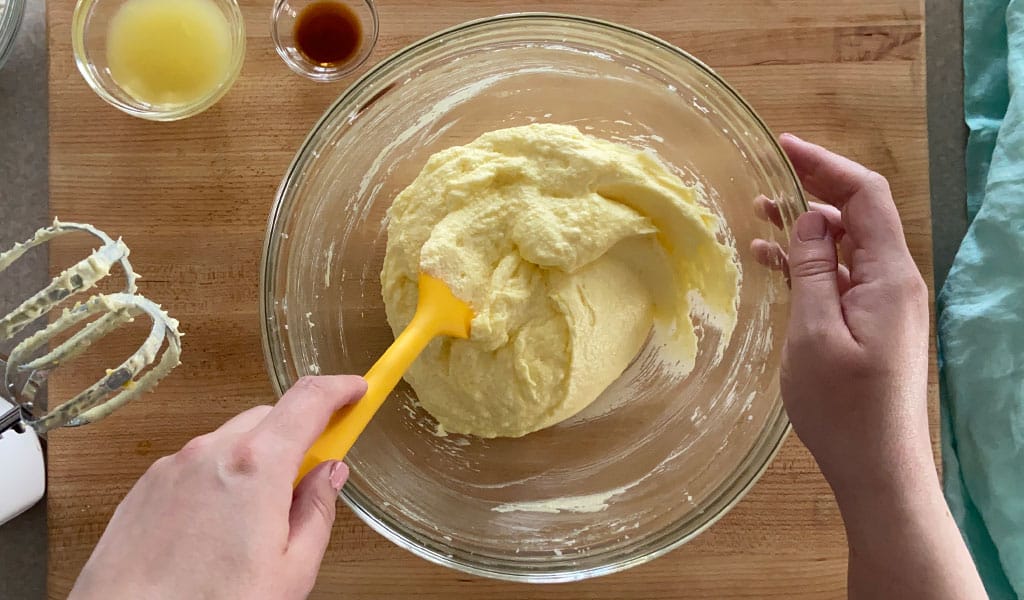 Lemon Cake Step 4- Add eggs and scrape mixing eggs into lemon cake mixture