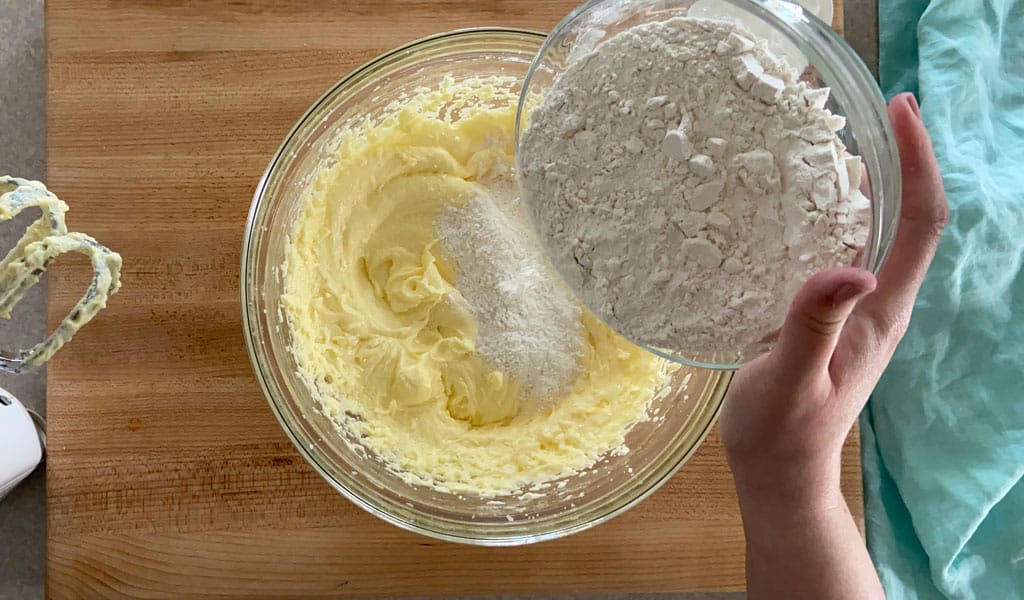 Lemon Cake Step 5- Add flour adding flour to lemon cake mixture