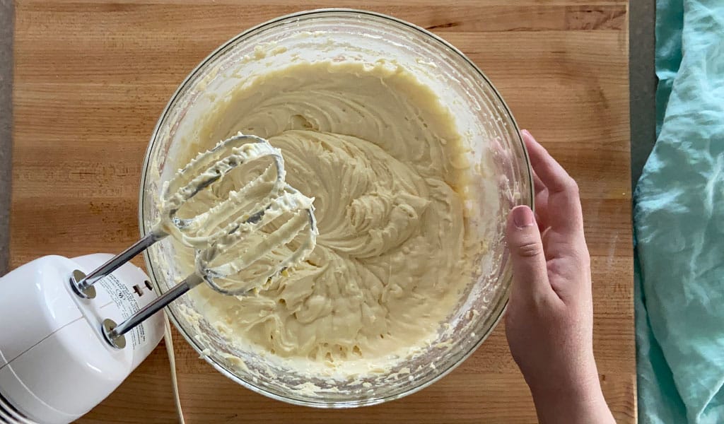 Lemon Cake Step 6- Add sour cream adding sour cream to lemon cake mixture