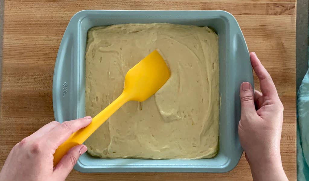 Lemon Cake Step 7- Pour batter into pan pouring batter into a pan
