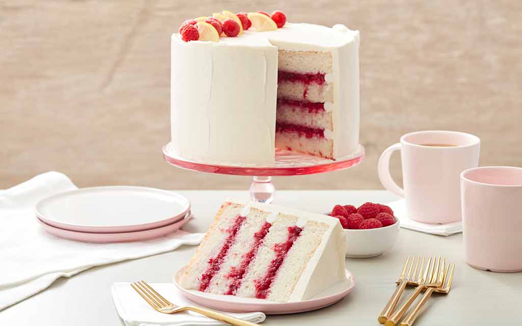 raspberry filled cake frosted with white buttercream frosting