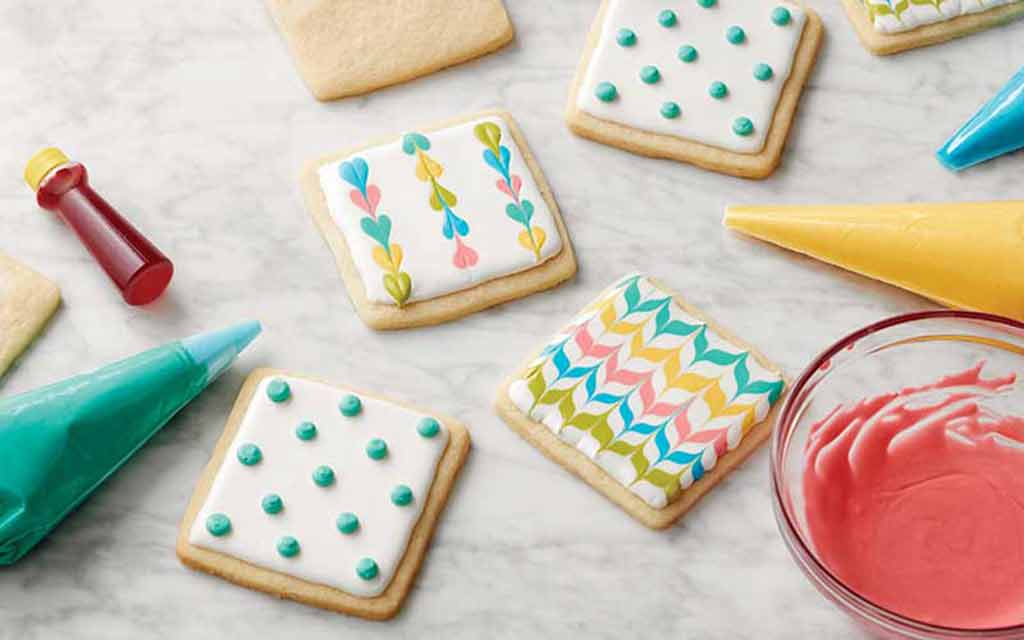 cookies decorated with colored royal icing dots and zig zags