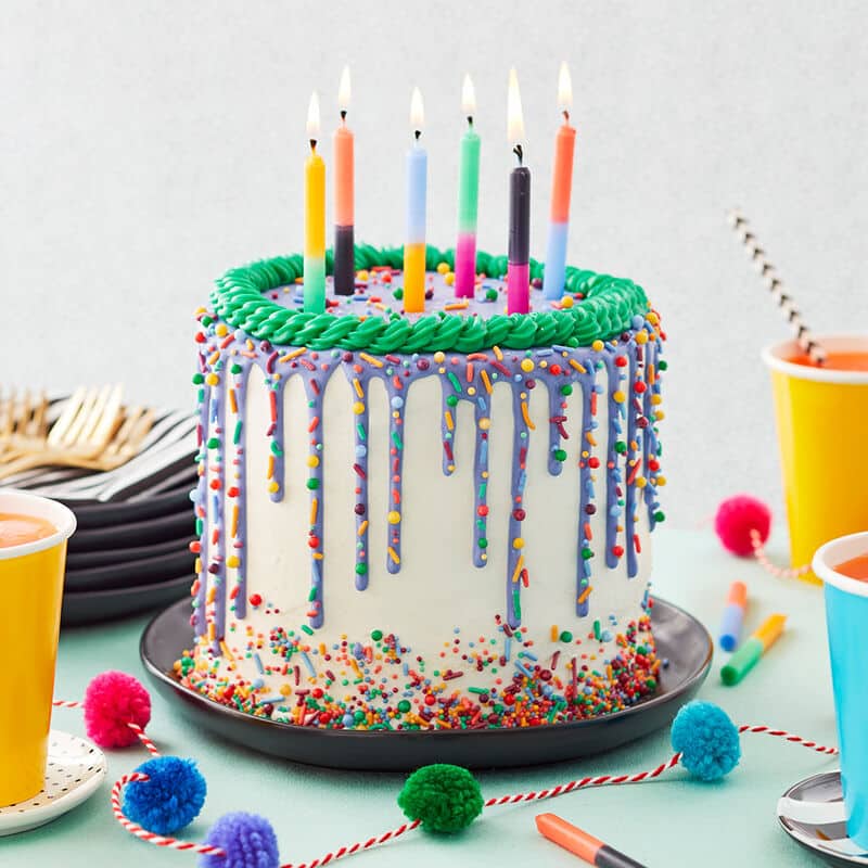 bright and bold birthday cake colorful drip cake with buttercream spiral and sprinkles