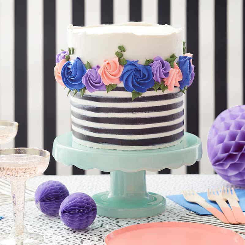 ring of rosettes cake black and white buttercream cake with pink and blue buttercream rosettes