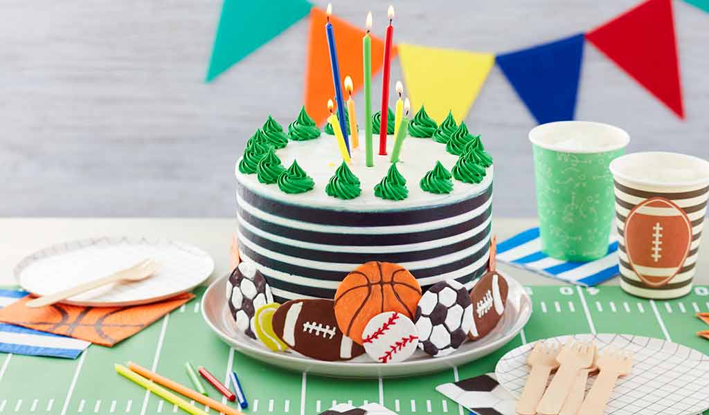sports-cake white buttercream cake decorated with coral and blue drop flowers using a drop flower decorating tip