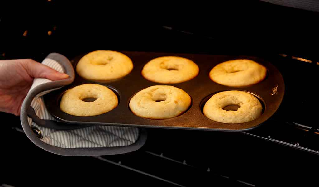 taking-baked-donuts-out-of-oven