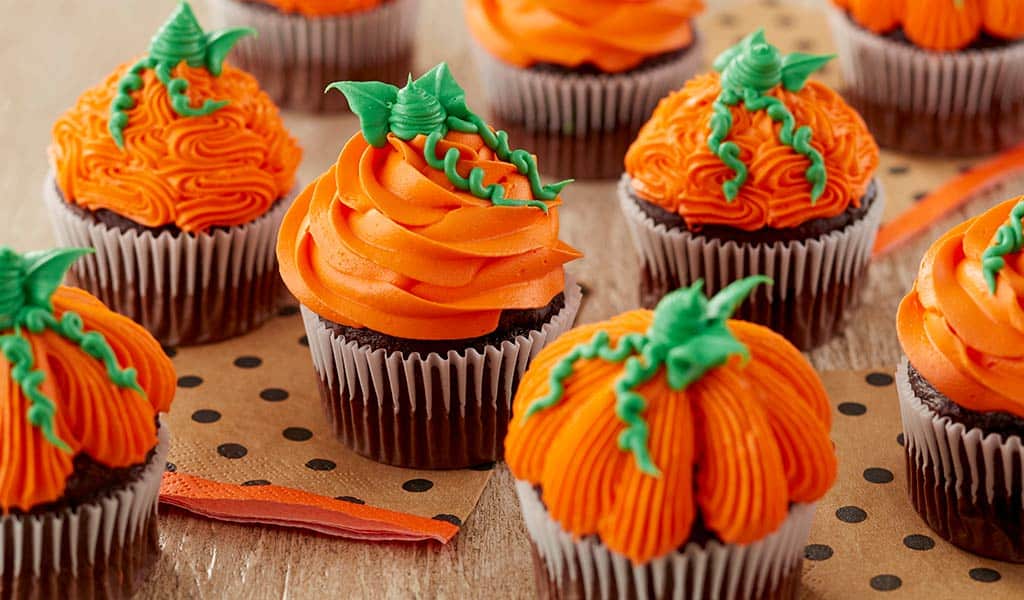 Pumpkin decorated pumpkins with orange buttercream piped different ways for the pumpkins