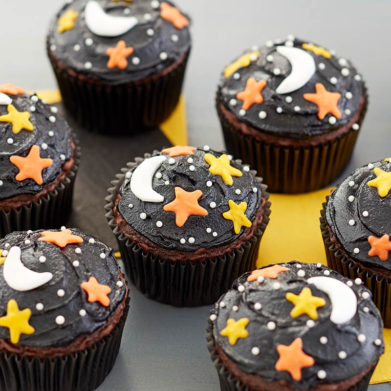Black frosting cupcakes topped with candy stars and moon
