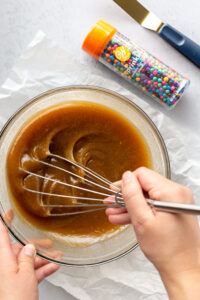 Whisking wet ingredients in glass bowl