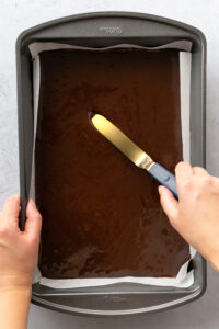 Spread batter evenly into parchment paper lined baking pan